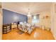 Comfortable bedroom with blue accent wall, chandelier, and ample natural light at 4318 Oak Ct, St Cloud, FL 34769