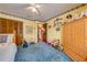 Bright bedroom featuring blue carpet, a wooden wardrobe, and a sunny ambiance at 4318 Oak Ct, St Cloud, FL 34769