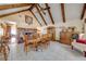 Elegant dining room featuring a brick fireplace and high ceilings with rustic wooden beams, creating a warm and inviting atmosphere at 4318 Oak Ct, St Cloud, FL 34769