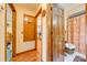 Hallway leads to the bathroom and a bedroom with a beautiful wood floor and wood trim at 4318 Oak Ct, St Cloud, FL 34769