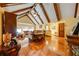 Spacious living room featuring vaulted ceilings, exposed beams, and gleaming hardwood floors at 4318 Oak Ct, St Cloud, FL 34769