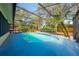 Backyard screened pool, palm trees and lush tropical landscaping at 4318 Oak Ct, St Cloud, FL 34769