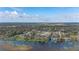 Expansive aerial view of a waterfront neighborhood with lush green trees and glistening lake, perfect for tranquil living at 4815 Cypress Dr, Lake Wales, FL 33898