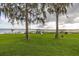 Lush, sprawling lawn featuring mature trees and a beautiful view of the lake, enhancing the appeal of this waterfront home at 4815 Cypress Dr, Lake Wales, FL 33898