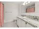 Bright bathroom featuring a double vanity with granite countertop and a well-lit mirror at 4815 Cypress Dr, Lake Wales, FL 33898