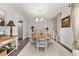 Bright dining room featuring hardwood floors, a decorative light fixture, and ample seating at 4815 Cypress Dr, Lake Wales, FL 33898