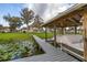 Scenic view of the home and expansive lawn from the boat dock, showcasing the property's waterfront setting at 4815 Cypress Dr, Lake Wales, FL 33898