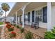 Welcoming front porch with classic rocking chairs and well-maintained landscaping at 4815 Cypress Dr, Lake Wales, FL 33898