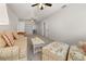 Inviting living room with neutral carpet, ceiling fans and open shelving at 4815 Cypress Dr, Lake Wales, FL 33898