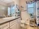 Well decorated bathroom with a large mirror, custom vanity, and neutral tones at 484 Villa Park Rd, Kissimmee, FL 34759