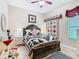 Cozy bedroom featuring a decorative quilt, complementary wall art and a ceiling fan at 484 Villa Park Rd, Kissimmee, FL 34759