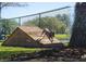 A playful dog enjoys an agility course ramp at the neighborhood dog park, offering outdoor recreation at 484 Villa Park Rd, Kissimmee, FL 34759