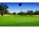 Lush green golf course with golfer and trees on a beautiful sunny day at 484 Villa Park Rd, Kissimmee, FL 34759