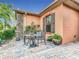 Cozy outdoor patio area with table, chairs, and potted plants, perfect for relaxing and enjoying the weather at 484 Villa Park Rd, Kissimmee, FL 34759