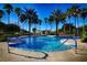 Gorgeous swimming pool with clear blue water, palm trees and an elegant gazebo at 484 Villa Park Rd, Kissimmee, FL 34759