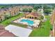 Aerial view of a community pool and sand volleyball court, surrounded by Mediterranean-style buildings and green space at 501 Terrace Ridge Cir # 501, Davenport, FL 33896