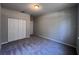 This bedroom features neutral walls and carpet, a closet, and a door to exit at 501 Terrace Ridge Cir # 501, Davenport, FL 33896