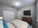 Neutral bedroom features a television, a dresser, and a double door closet at 501 Terrace Ridge Cir # 501, Davenport, FL 33896