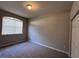 This bedroom features neutral walls and carpet, a closet, and a window at 501 Terrace Ridge Cir # 501, Davenport, FL 33896