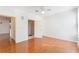 A well-lit main bedroom with wood floors, white walls, and an open doorway to the en-suite bathroom at 5025 Wellington Park Cir # 68, Orlando, FL 32839