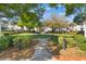 Community green space featuring a fountain, walking path and mature trees at 5025 Wellington Park Cir # 68, Orlando, FL 32839