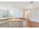 View of kitchen with laminate counters, sink, wood floors, and view to the living area at 5025 Wellington Park Cir # 68, Orlando, FL 32839