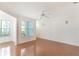 Bright living room featuring wood floors, two windows with natural light, and a ceiling fan at 5025 Wellington Park Cir # 68, Orlando, FL 32839