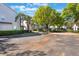 Exterior view of the property showing the parking lot surrounded by lush greenery and well-maintained buildings at 5025 Wellington Park Cir # 68, Orlando, FL 32839