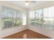 Bright sunroom with hardwood floors and large windows offering outdoor views at 5025 Wellington Park Cir # 68, Orlando, FL 32839