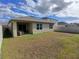 View of backyard with covered patio, windows, and fence at 5295 Timberland Ave, St Cloud, FL 34771