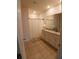 Bathroom featuring double vanity with granite countertops, tile flooring, and a shower with a neutral-colored curtain at 5295 Timberland Ave, St Cloud, FL 34771