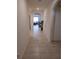 Bright hallway showcasing tiled floors and arched doorways, offering a glimpse into the home's living spaces at 5295 Timberland Ave, St Cloud, FL 34771