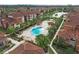 Aerial view of community pools, lounge chairs, cabanas, surrounding landscaping and pond at 5560 Metrowest Blvd # 304, Orlando, FL 32811