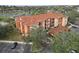 Aerial view of condo buildings showcasing red tiled roofs, exterior balconies, and the surrounding landscape and parking at 5560 Metrowest Blvd # 304, Orlando, FL 32811