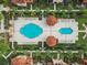 Aerial view of community pools, lounge chairs and shade cabanas in a landscaped courtyard at 5560 Metrowest Blvd # 304, Orlando, FL 32811