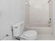 Bathroom featuring a toilet, bathtub and shower with white tiling at 5560 Metrowest Blvd # 304, Orlando, FL 32811