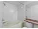 Bright bathroom with a shower-tub, white tile, and a matching toilet at 5560 Metrowest Blvd # 304, Orlando, FL 32811