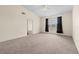 Bedroom featuring neutral walls, plush gray carpeting, and a ceiling fan with attached lighting at 5560 Metrowest Blvd # 304, Orlando, FL 32811