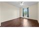 Bedroom features hardwood floors and a large window for natural light at 5560 Metrowest Blvd # 304, Orlando, FL 32811