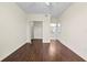 Empty bedroom with hard wood floors, neutral walls, closet, and an en-suite bathroom at 5560 Metrowest Blvd # 304, Orlando, FL 32811