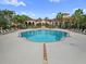 Community pool area with lounge chairs and beautifully designed community buildings at 5560 Metrowest Blvd # 304, Orlando, FL 32811