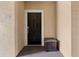 Apartment front door featuring a dark wood door, unit number, and a small wooden bench outside at 5560 Metrowest Blvd # 304, Orlando, FL 32811