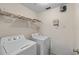 Practical laundry area with a washer, dryer, and storage shelf for convenience at 5560 Metrowest Blvd # 304, Orlando, FL 32811