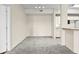 Open carpeted living room connects to the dining space, next to an adjacent kitchen with white cabinetry at 5560 Metrowest Blvd # 304, Orlando, FL 32811