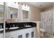 Bathroom with double sink, granite countertop, white cabinets, and shower at 565 Cresting Oak Cir # 87, Orlando, FL 32824