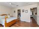 Bedroom with wood flooring, ceiling fan, and view to bathroom at 565 Cresting Oak Cir # 87, Orlando, FL 32824