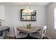 Stylish dining area with unique table and chairs, mirrored bar area, and modern lighting at 565 Cresting Oak Cir # 87, Orlando, FL 32824