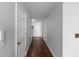 Hallway features include hardwood flooring and neutral paint at 565 Cresting Oak Cir # 87, Orlando, FL 32824