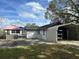 Backyard with a covered hot tub, a storage unit and carport at 610 Illinois Ave, St Cloud, FL 34769