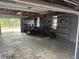 Interior view of the garage area with lots of shelving at 610 Illinois Ave, St Cloud, FL 34769